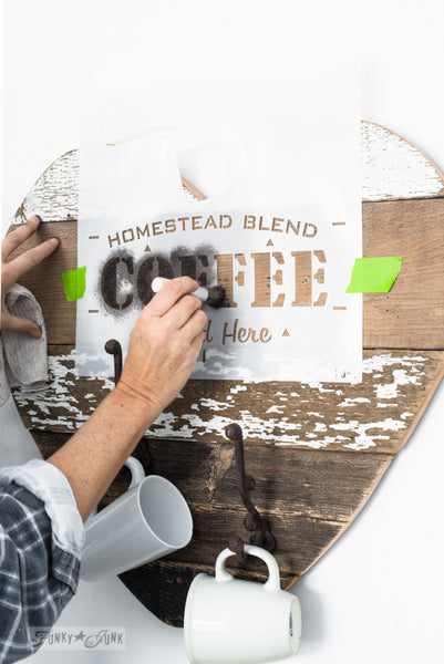 Homestead Blend Coffee - Served Here by Funky Junk's Old Sign Stencils is a 1-piece coffee-themed stencil that offers visions of your favorite coffee shop! Designed with bold coffee letters, subtext, and a steaming mug graphic. This coffee stencil is perfect for stenciling on crates, pillows, tv trays, signs and more!