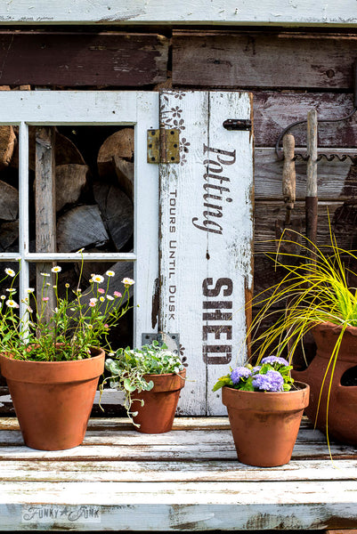 Potting Shed shutters on a shed with Funky Junk's Old Sign Stencils. Paint professional looking vintage farmhouse styled garden signs onto reclaimed wood with a stencil in minutes!