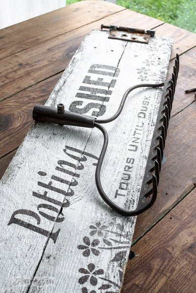 Potting Shed rake sign on a shed with Funky Junk's Old Sign Stencils. Paint professional looking vintage farmhouse styled garden signs onto reclaimed wood with a stencil in minutes!