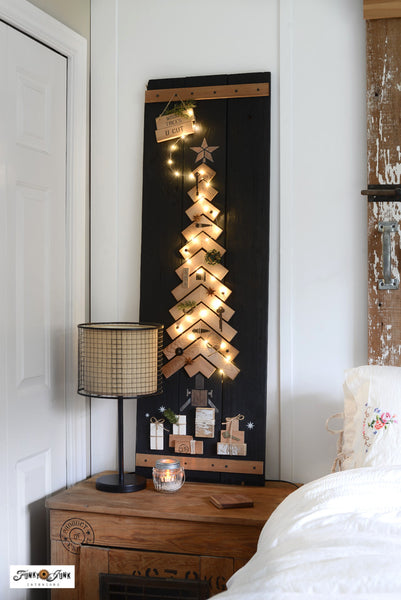 Illuminated Chevron Christmas tree as wall decor in a bedroom with Funky Junk's Old Sign Stencils.