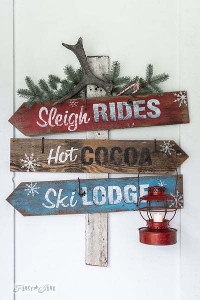 Winter directional signs made with Sleigh Rides from Funky Junk's Old Sign Stencils. Create professional painted winter themed sleigh styled signs onto reclaimed wood in minutes with this festive, wintery stencil design!